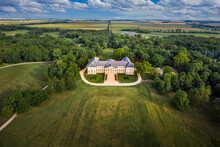 Deg, Hungary - Aerial View Of The Famous Festetics Palace, Classicist Castle Surrounded By The Largest English Park In Fejer County On A Summer Morning With Green Trees And Blue Sky With Clouds