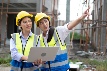 Wall Mural - Engineers on building site. Engineer are working contruction on site plans to build high-rise buildings building. Architect caucasian man working with colleagues mixed race in the construction site.