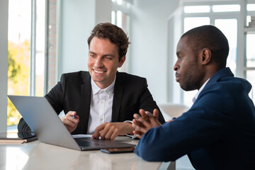 African American businessman wearing formal suit talking to smil