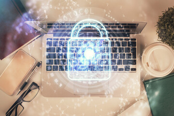 Poster - Double exposure of lock hologram drawing over study table background with computer. Concept of data security. Top view.