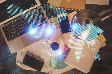 Poster - Social network hologram drawings over computer on the desktop background. Top view. Double exposure.