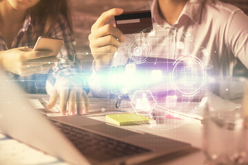 Poster - Double exposure of man and woman on-line shopping holding a credit card and social network theme hologram drawing. People connecting and E-commerce pay on-line concept.
