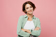 © ViDi Studio - Young smiling happy cheerful woman 20s she wear green shirt white t-shirt hold hands crossed folded look camera isolated on plain pastel light pink background studio portrait People lifestyle concept
