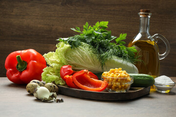 Chinese cabbage and different products on wooden table