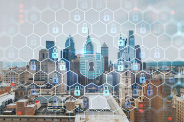 Aerial panorama city view of Philadelphia financial downtown at day time, Pennsylvania, USA. Glowing Padlock hologram. The concept of cyber security to protect companies confidential information