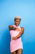 Black androgynous model in pink dress dancing
