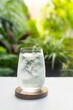 © p-fotography - A refreshing glass of ice water on bright green morning light background.