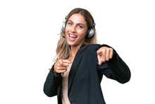 Telemarketer Pretty Uruguayan Woman Working With A Headset Over Isolated Background Pointing To The Front And Smiling