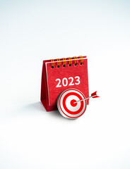 Wall Mural - Happy new year 2023 background. 3d target icon with red 2023 year numer desk calendar cover red color standing on white background, vertical style. Business goals and success concepts.