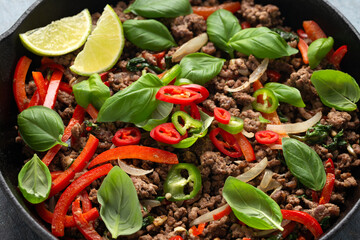 Wall Mural - Pad Kra Pao stir fried thai basil, minced beef in iron cast pan