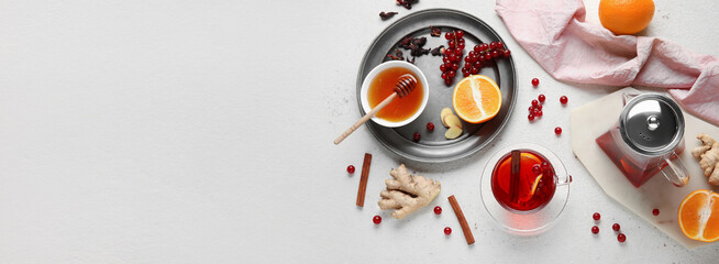 Tasty fruit tea with honey on light background with space for text