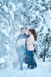 © Kate - A couple in love kissing while walking through a fabulously snow-covered winter forest