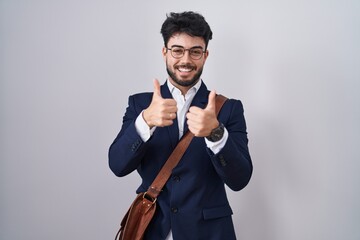 Sticker - Hispanic man with beard wearing business clothes success sign doing positive gesture with hand, thumbs up smiling and happy. cheerful expression and winner gesture.