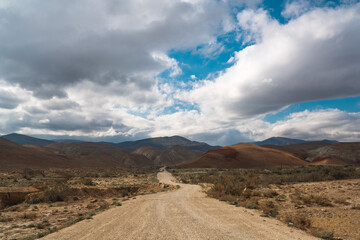 Wall Mural - Winding dirt road in the mountains