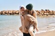 © Krakenimages.com - Mand and woman couple hugging each other holding on back at seaside
