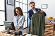 © Krakenimages.com - Middle age man and woman shop assistant workers working at clothing store