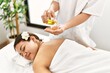 © Krakenimages.com - Young latin woman relaxed having back massage with oil at beauty center