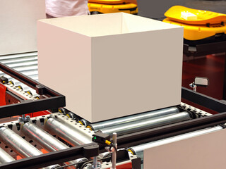Poster - empty box rides on conveyor. Delivery service warehouse. Cardboard box on warehouse conveyor. Packing orders in delivery service. Conveyor to speed up delivery process concept. Modern storage