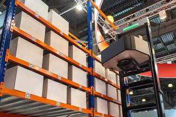 Poster - Robotization warehouse. Robot for placing warehouse parcels. Innovative warehouse technologies. Fulfillment process without people. Automated loader next to racks. Robotization of storage business