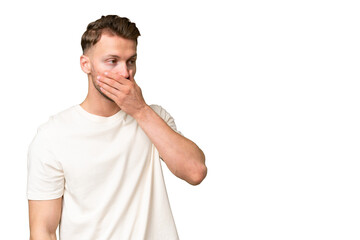 Wall Mural - Young blonde caucasian man over isolated background doing surprise gesture while looking to the side