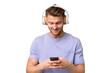 © luismolinero - Young blonde caucasian man over isolated background listening music and looking to mobile