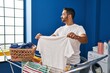 © Krakenimages.com - Young hispanic man smiling confident hanging clothes on clothesline at laundry room