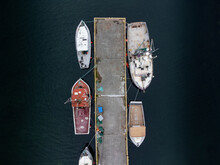 Looking Down View Of Fishing Boats Tied To A Dock On The East Coast Of Canada In Newfoundland.