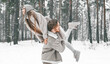 © velirina - Love romantic young couple. Guy spinning girl in snowy winter forest with trees. Walking, having fun, laughing in stylish clothes, fur coat,jacket, woolen shawl. Snow lovestory. Romantic date,weekend