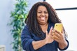 African american woman using smartphone standing at home