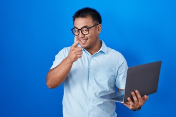 Sticker - Chinese young man using computer laptop pointing fingers to camera with happy and funny face. good energy and vibes.