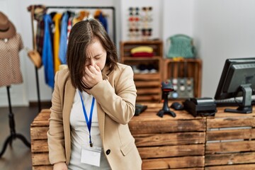 Sticker - Young down syndrome woman working as manager at retail boutique tired rubbing nose and eyes feeling fatigue and headache. stress and frustration concept.