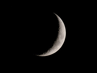 view of the crescent moon through telescope.