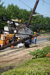 Wall Mural - Electric utility repair crew on the scene of a broken wooden utility pole