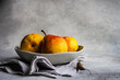 © RooM The Agency - Close-Up of a bowl of pears on a table with a napkin