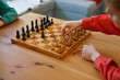 Two boys playing wooden chess