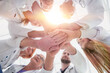 © ASDF - close up. group of different doctors putting their hands together