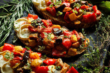 Wall Mural - Ratatouille sandwich with sourdough bread with addition of goat cheese and fresh herbs, focus on sandwich inside, close up view