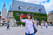 Woman tourist taking selfie in an old european city, in front of historical building