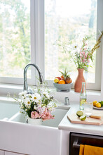 Flowers In Sink By Window In Kitchen