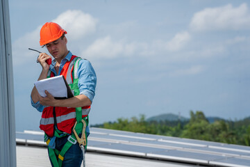 Aufkleber - Engineer or worker installing a solar cell on the roof in warehouse factory,Eco technology for electric power.