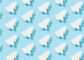 Wall Mural - Pattern composition of white Christmas trees on pastel blue background. Minimalist isometric winter concept.