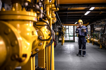 Wall Mural - Refinery worker engineer controlling crude oil production inside factory.