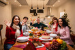 © Kawee - Multi-ethnic big family celebrating Christmas party together in house.