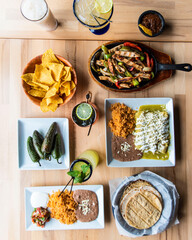 Canvas Print - Top view of appetizing Mexican dishes on a wooden surface - the concept of Mexican cuisine