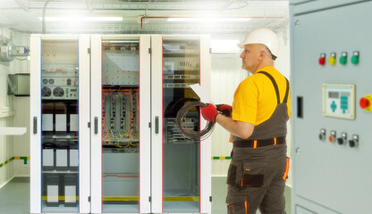 Poster - Installation network equipment. Man is Internet provider specialist. Internet company employee in front of north cabinet. Man in work uniform set up network equipment. Network technology maintenance