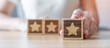 © Jo Panuwat D - hand holding Star block. Customer choose rating for user reviews. Quality, Service rating, ranking, customer review, satisfaction, evaluation and feedback concept