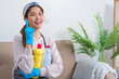 Hygiene cleaning concept, Housemaid doing thumbs up and holding cleaning solution to cleaning house