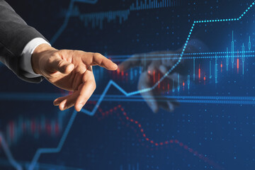 Poster - business man hand pointing at creative candlestick forex chart index hologram on blurry blue background with reflection. Trade, business market and finance analysis concept. Double exposure.