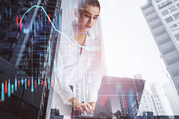 Poster - businesswoman using notebook with creative candlestick forex chart index hologram on blurry background. Trade, business market and finance analysis concept. Double exposure.