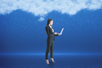 Poster - Attractive young european businesswoman with laptop standing on blurry digital blue background with abstract cloud. Cloud computing, big data and digital transformation concept.